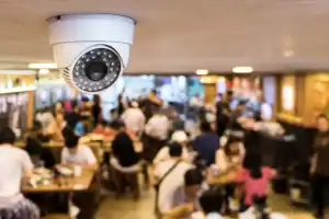High-definition CCTV security camera monitoring a busy restaurant interior, capturing customer activities, ensuring safety, and enhancing surveillance coverage for improved security.