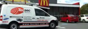 CCTV security and communication solutions van outside Tecsec store in front of McDonald's.
