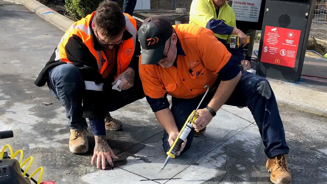 Worksite CCTV installation in progress with technicians securing security cameras and communication systems for enhanced surveillance and safety.